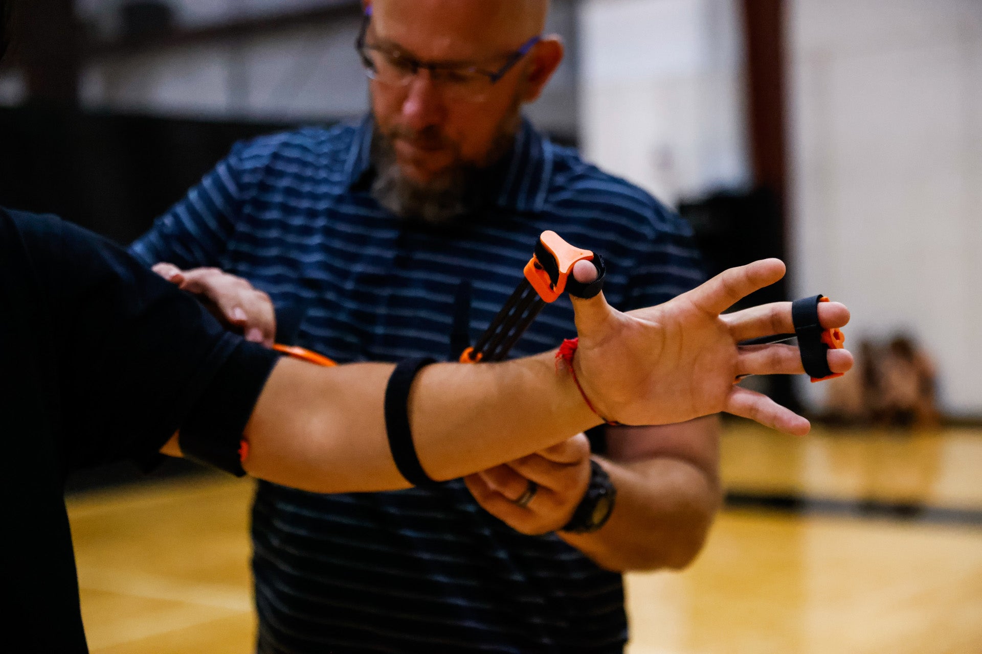 Rob White, Perfec'Shot founder, helping player adjust his shooting aid, model A-21